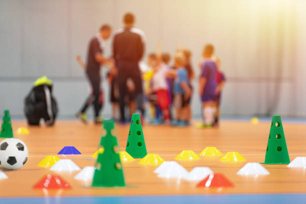 futsal soccer training court kids in a group with coaches in